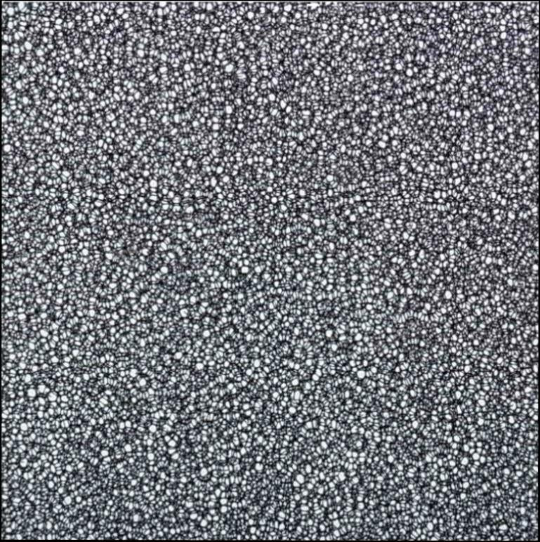 Close-up view of black and white reticulated foam sheets for speakers with a porous texture